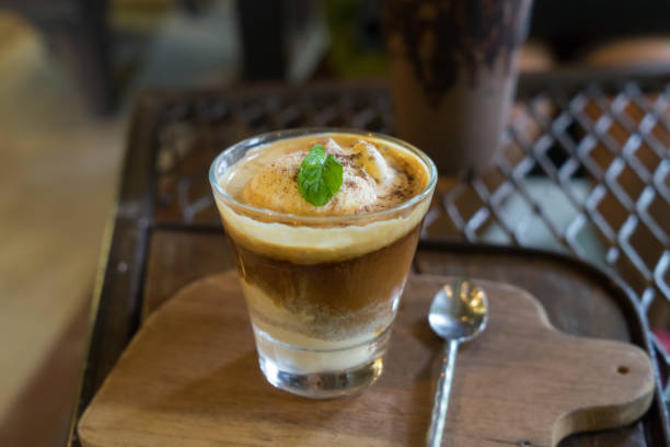 istock Coffee float with vanilla ice cream on wooden table in morning. 877504086