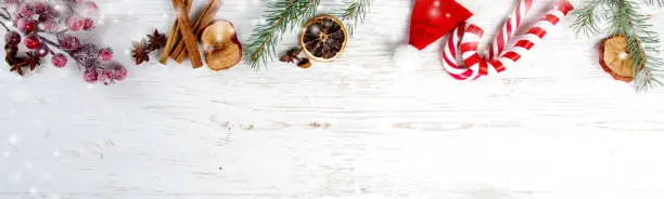 Photo of Christmas decorations and spices on white wooden background