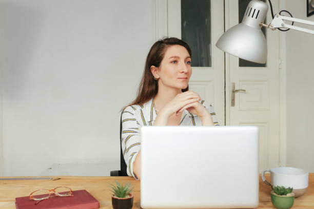 istock young woman working on laptop 877505140