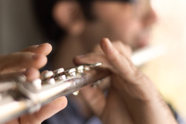 istock Male hands playing a flut. 877505338