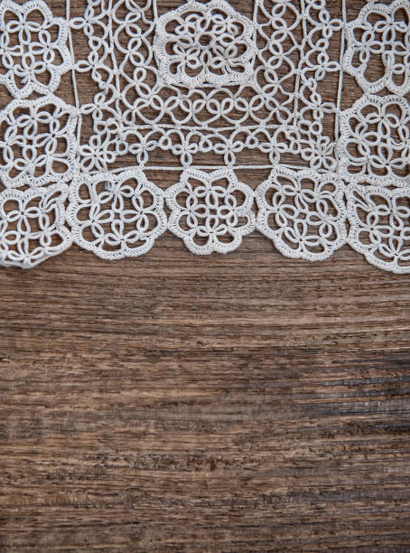 istock Vintage background with lace on the old wood 877507844