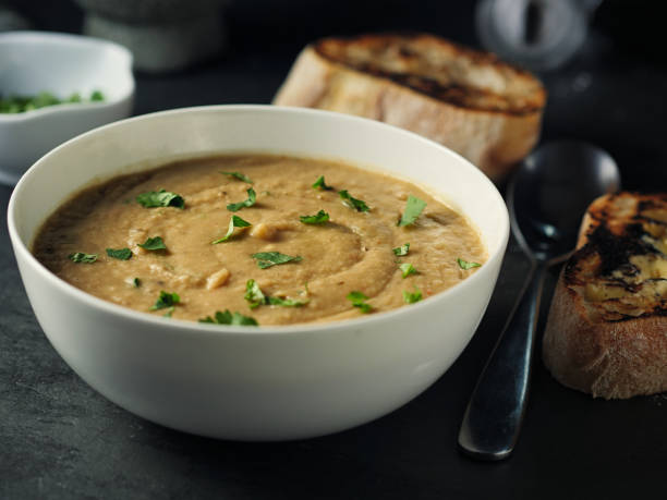 Home made freshness spicy chickpea and red lentils soup with fine chopped coriander