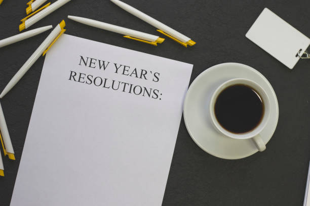 istock New Year's resolutions paper, white pens and a badge 877508316