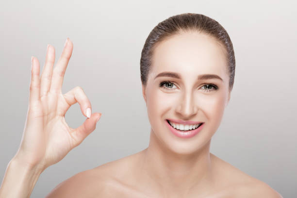 istock young woman showing gesture Ok 877508548