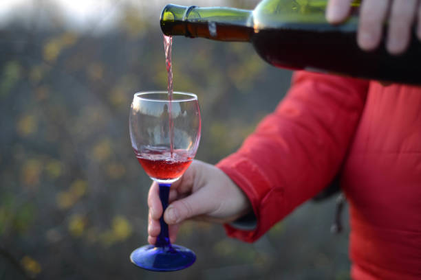 istock Red wine pouring into glass 877511518