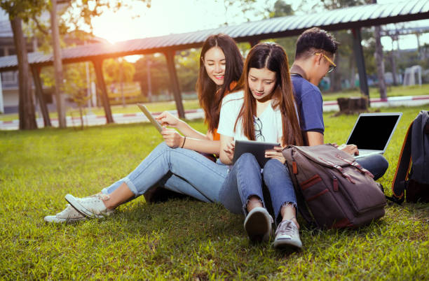istock Students young asian together working study smiling with tablet,laptop computer at university high school campus,college in summer holiday relaxation 877511538