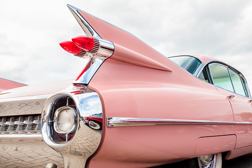 Den Bosch, The Netherlands – May 14, 2017: Rear end of a classic pink Cadillac fifties car in Den Bosch, The Netherlands