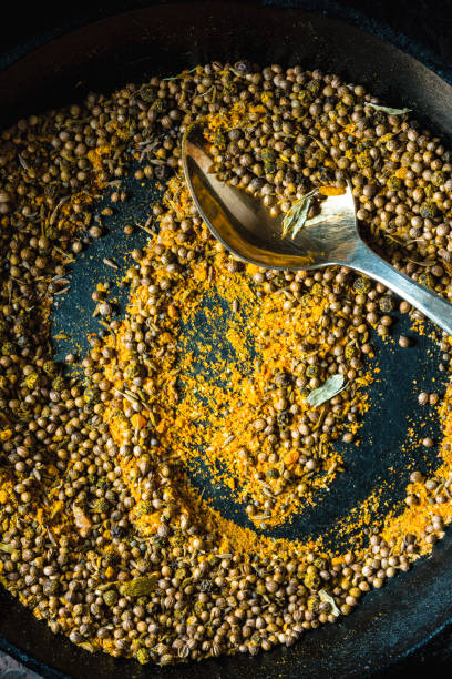 istock Cooking masala for curry in pan on dark background vertical 877529940