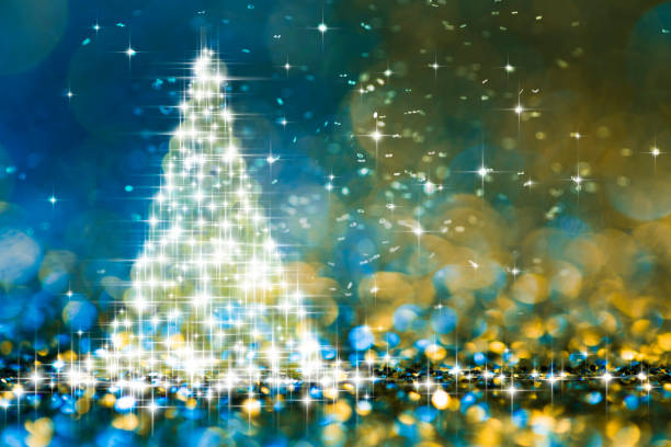 istock Shiny Christmas tree in glitter defocused background - Bokeh Blue Gold 877553572