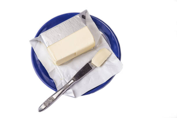 istock Butter on the blue plate  on the white background. 877554370