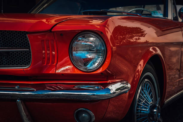 Classic American car from the sixties in bright red color Closeup and partial view of a beautiful classic American car from the sixties in bright red color car show photos stock pictures, royalty-free photos & images