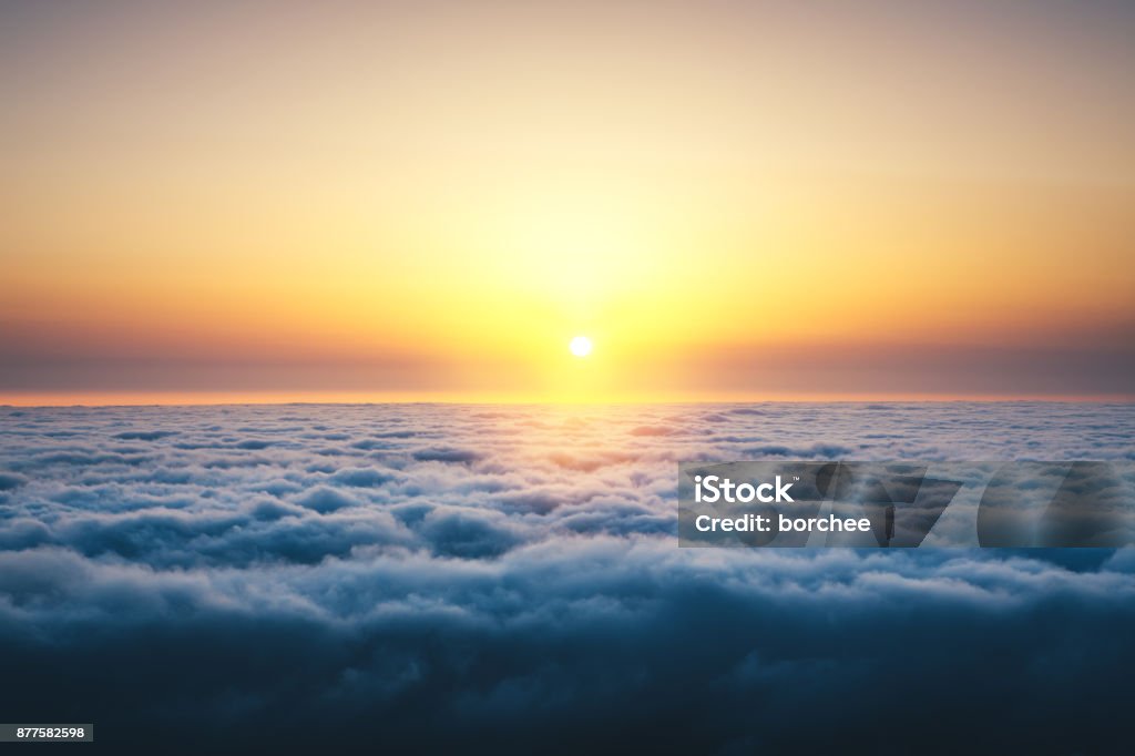 Above The Clouds At Sunrise Colorful sunrise above the clouds. Sunrise - Dawn Stock Photo