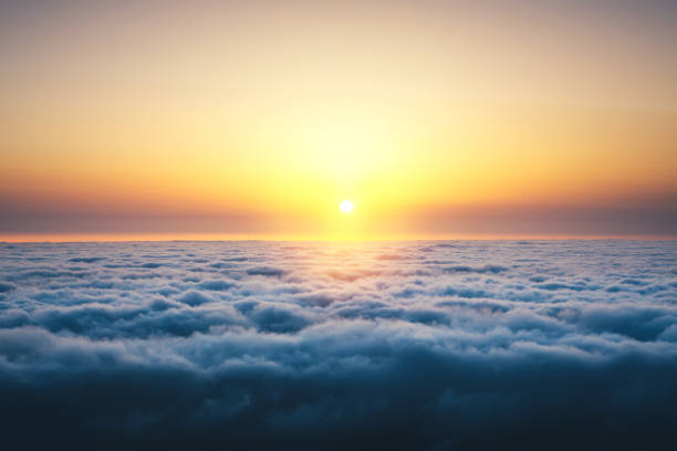 Above The Clouds At Sunrise Colorful sunrise above the clouds. above cloud stock pictures, royalty-free photos & images