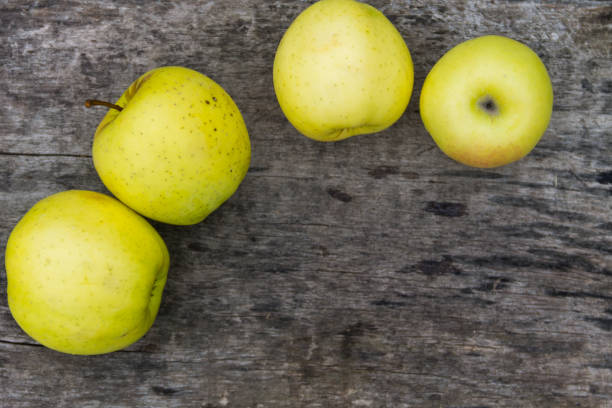 istock Ripe green apples on rustic wooden table 877590920