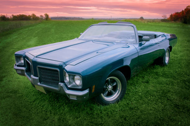 istock Old blue 1971 convertible car parked at sunset 877618646