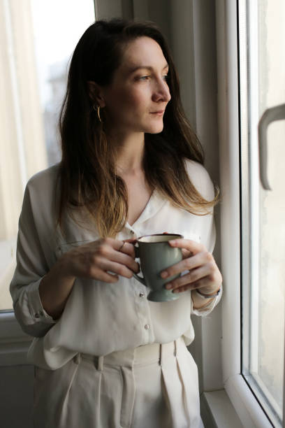 istock young woman drinking coffee 877633370