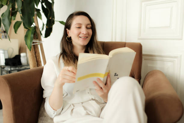 istock young woman reading a book 877633588
