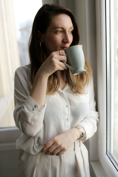 istock young woman drinking coffee 877633784