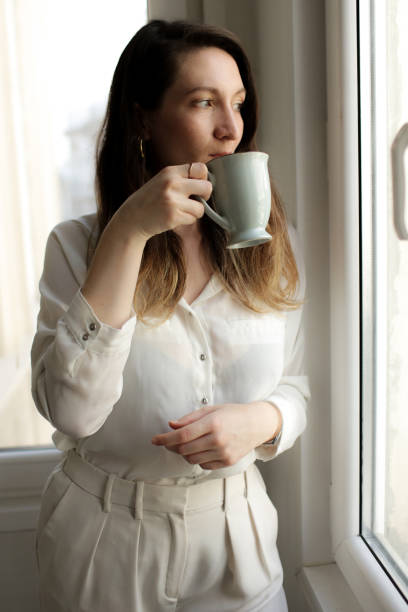 istock young woman drinking coffee 877633824