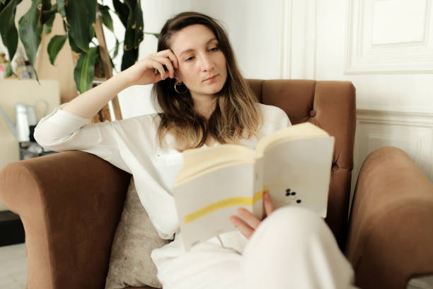 istock young woman reading a book 877633828