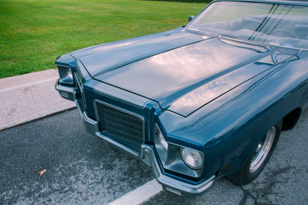 istock Old blue 1971 convertible car parked at sunset 877644034