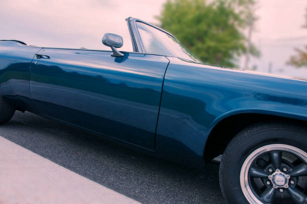 istock Old blue 1971 convertible car parked at sunset 877648314