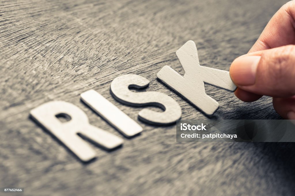 Risk Wood Letters Hand place wood letters for RISK word Risk Stock Photo