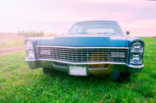 istock Old blue 1967 car parked at sunset in a field 877660774