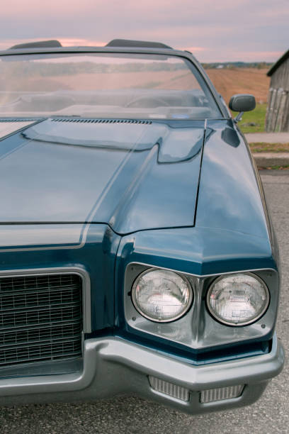 istock Old blue 1971 convertible car parked at sunset 877665362