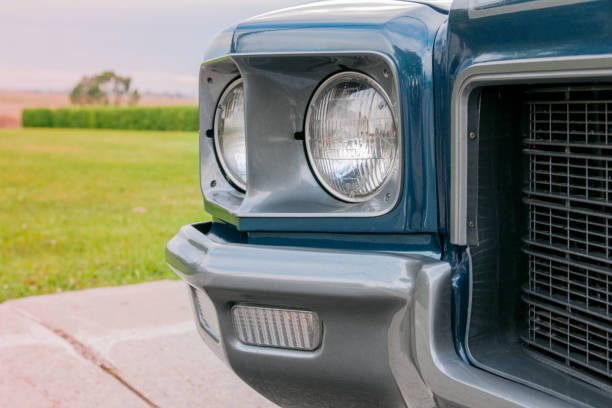 Old blue 1971 convertible car parked at sunset
