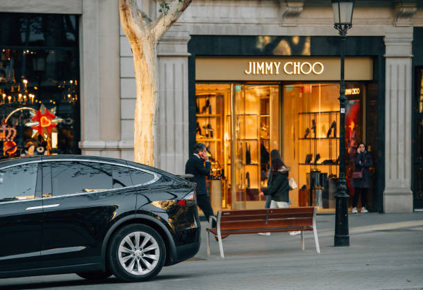 Luxury electric Tesla Model X SUV parked in front of the Jimmy Choo Barcelona: Luxury electric Tesla Model X SUV parked in front of the Jimmy Choo fashion boutique clothes store on Avenue Diagonal avenida diagonal stock pictures, royalty-free photos & images