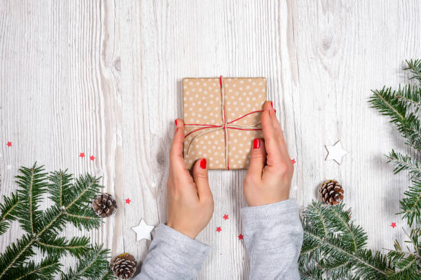 Gift box in hands with Christmas background stock photo