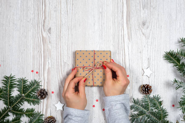 Gift box in hands with Christmas background stock photo