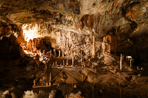Stalactites and stalagmites in an underground cavern - Postojna cave, Slovenia, Europe
