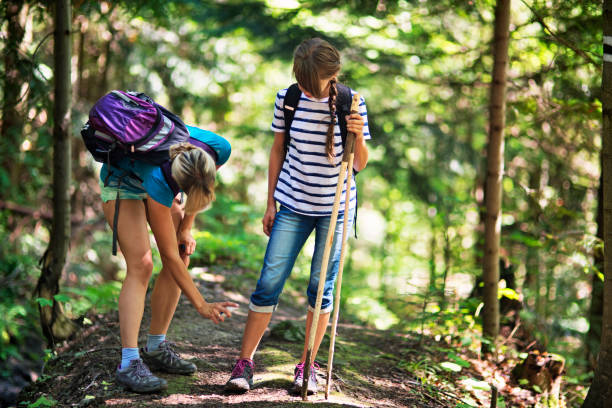 mother applying tick repellent on daughter - insect repellant imagens e fotografias de stock