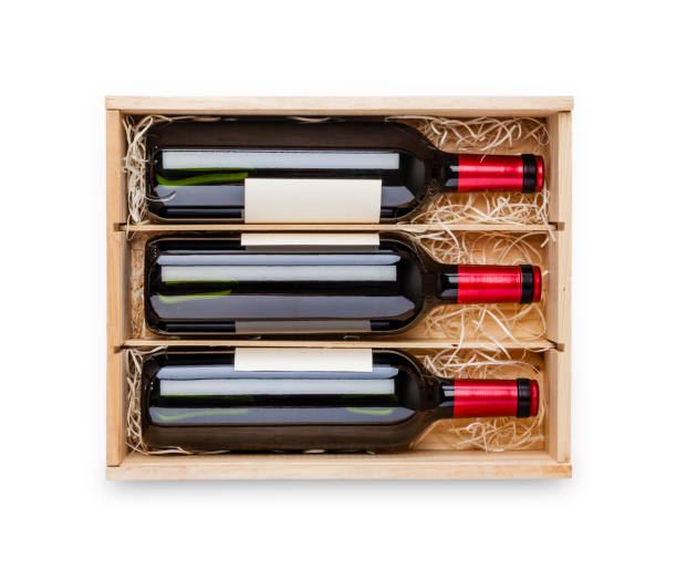 istock Opened wooden box with three red wine bottles inside it isolated on white background 877714480