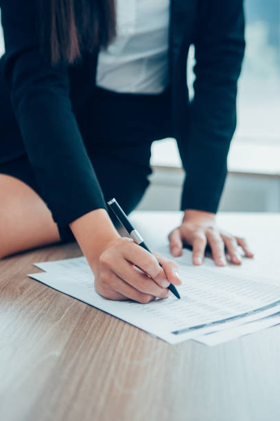 istock Cropped View of Woman Working with Document 877714740