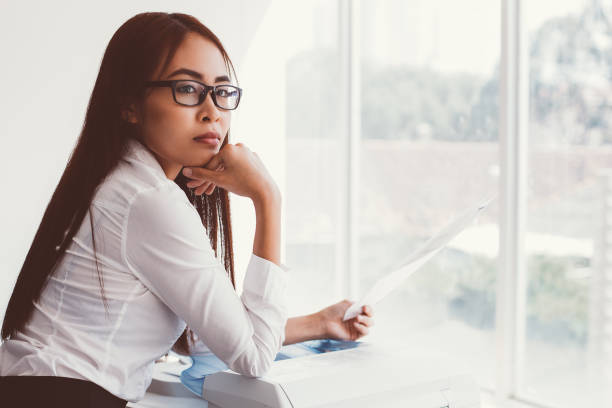 Pensive Female Secretary with Document at Window