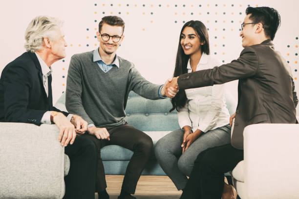 istock Smiling Business Partners Shaking Hands at Meeting 877714790
