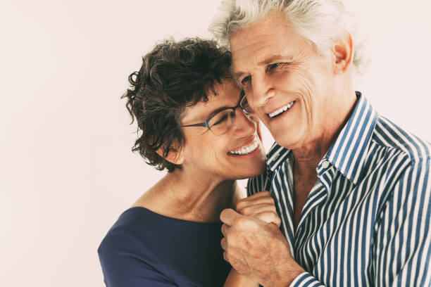 istock Smiling Elderly Couple Smiling and Embracing 877714832