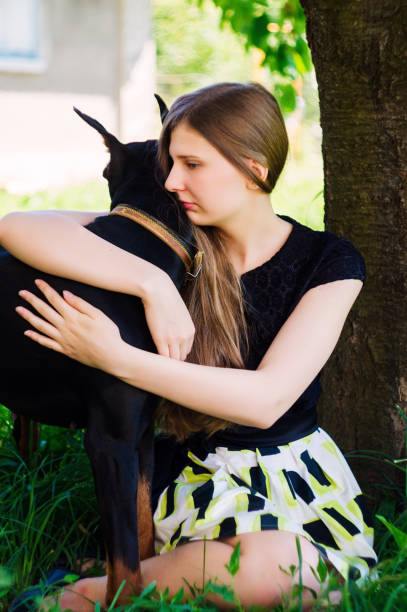 istock A girl in a park with a dog 877714870