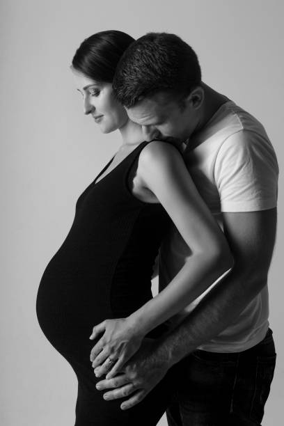 istock Young man and pregnant woman in studio 877715300