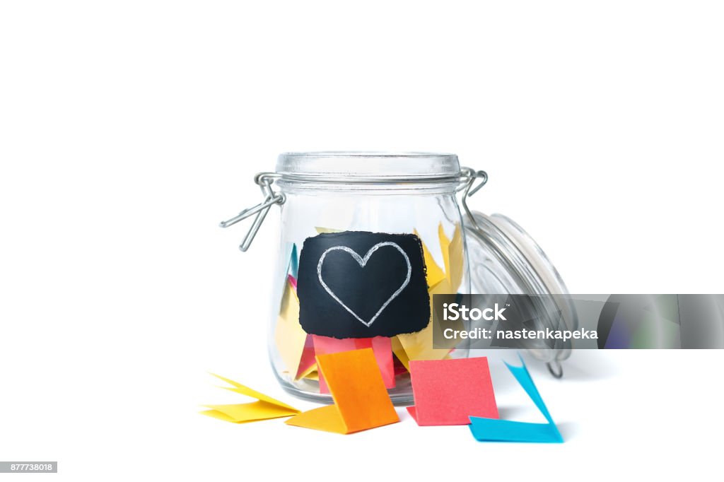Open Bank with stickers on white background Open Bank with colorful stickers on a white background with white chalk-drawn heart Jar Stock Photo
