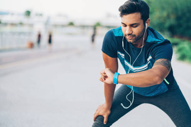istock Athlete looking at his smart watch 877744918
