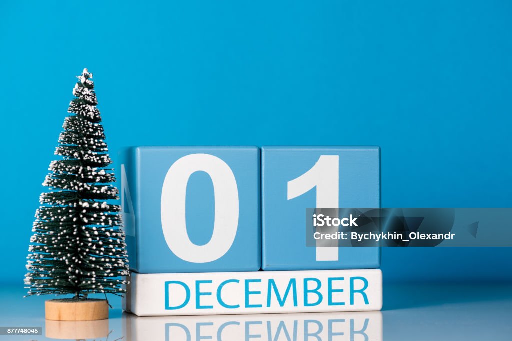 December 1st. Day 1 of december month, calendar with little christmas tree on blue background. Winter time. New year concept December 1st. Day 1 of december month, calendar with little christmas tree on blue background. Winter time. New year concept. First Place Stock Photo