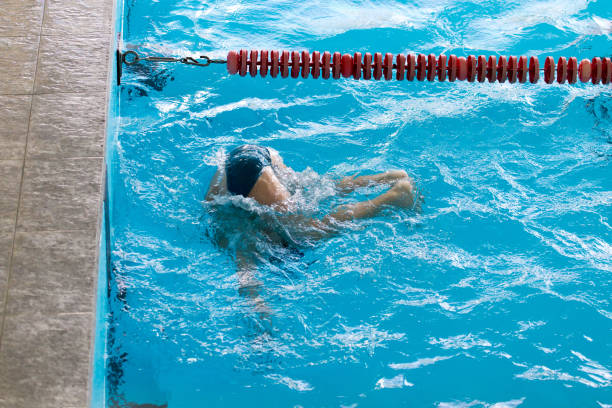 istock boy on a swim in a sports pool 877748314