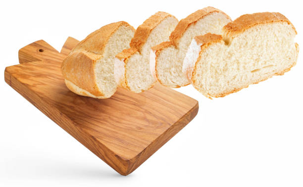 slicing fresh bread on cutting board