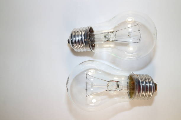 istock two incandescent lamps close-up on a white background 877760352