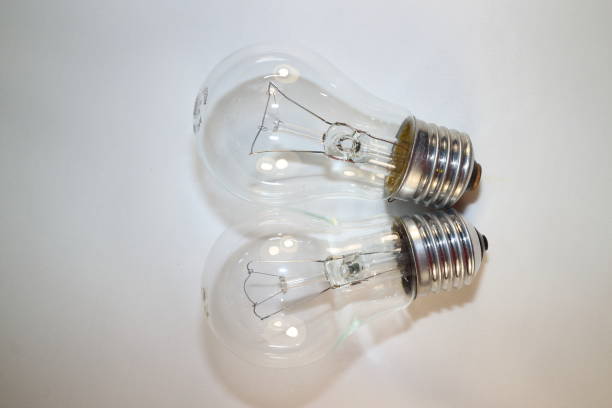 istock two incandescent lamps close-up on a white background 877760378