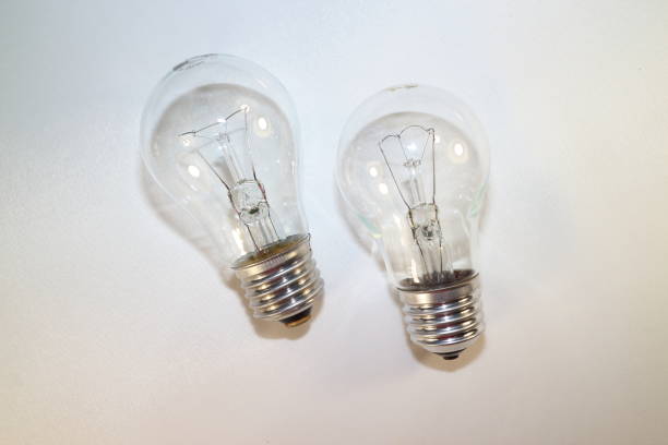 istock two incandescent lamps close-up on a white background 877760468
